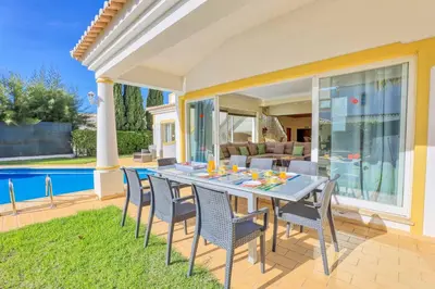 a patio with a table and chairs and a pool at Villa Jeanic in Galé