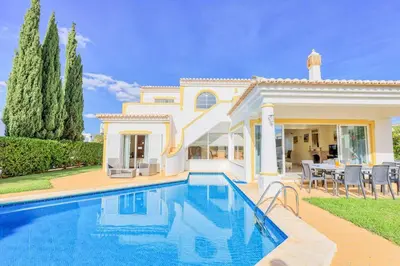 a villa with a swimming pool in front of a house at Villa Jeanic in Galé