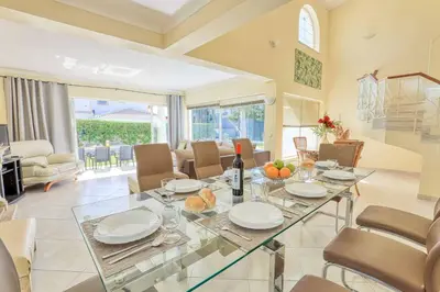 a dining room with a glass table and chairs at Villa Jeanic in Galé