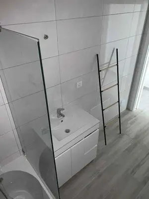 a bathroom with a sink and a glass shower at CASA CANELAS in Faro