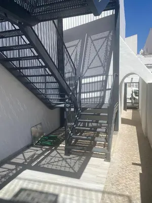 a stairway leading up to a building with a metal structure at CASA CANELAS in Faro