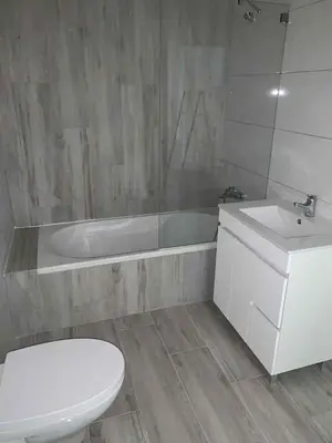 a bathroom with a toilet and a tub and a sink at CASA CANELAS in Faro