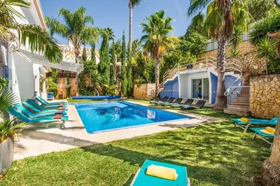 a backyard with a swimming pool and palm trees at Villa Paris in Terras Novas