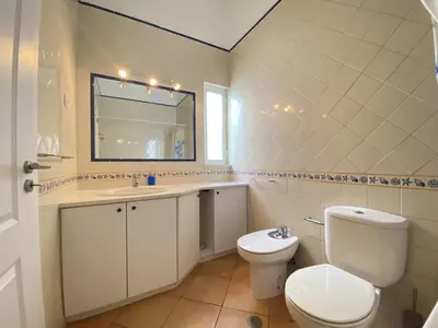 a bathroom with a toilet and a sink and a mirror at Albufeira Quinta da Balaia Charming by Homing in Albufeira
