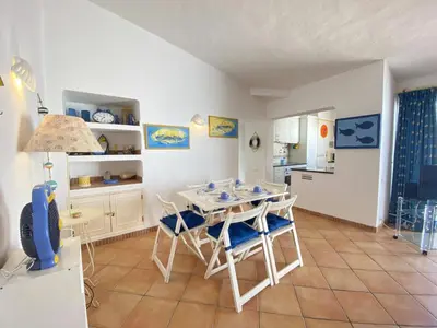 a kitchen and dining room with a table and chairs at Albufeira Quinta da Balaia Charming by Homing in Albufeira