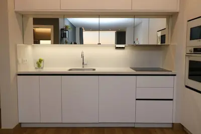 a kitchen with white cabinets and a sink at Blue over blue in Quarteira
