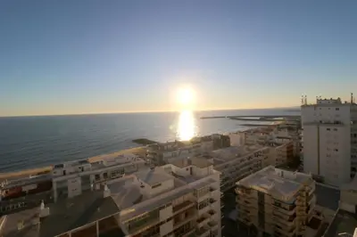 an image of the sun setting over the ocean at Blue over blue in Quarteira