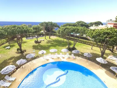 an overhead view of a swimming pool with umbrellas and chairs at Apartment Ipanema 1 by Algarve Vacation in Albufeira