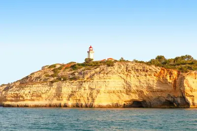 a lighthouse on an island in the water at Apartment Ipanema 1 by Algarve Vacation in Albufeira
