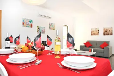 a table with plates and wine glasses on a red table cloth at Apartment Ipanema 1 by Algarve Vacation in Albufeira