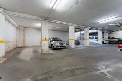 a parking garage with a car parked in it at Peaceful 1 BDR Apartment W/ Balcony by LovelyStay in Almancil
