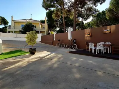 a patio with chairs and a table and a fence at Villa | w/ Private Pool, Tennis Courts & Golf Putt in Vilamoura