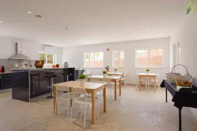 a kitchen and dining room with tables and chairs at Villa | w/ Private Pool, Tennis Courts & Golf Putt in Vilamoura