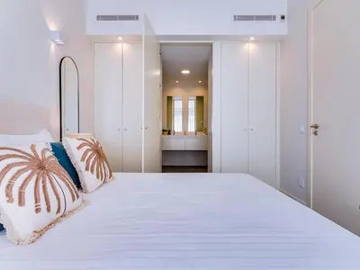 a bedroom with a large white bed with two pillows at AL - Boho Chic Villa Country Club in Vilamoura