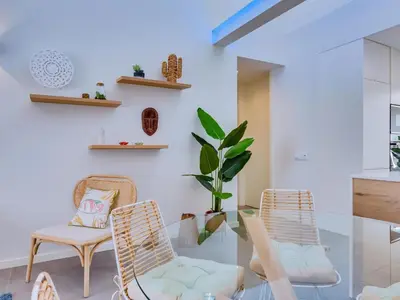 a living room with two chairs and a glass table at AL - Boho Chic Villa Country Club in Vilamoura
