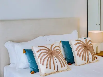 a white bed with four pillows on it at AL - Boho Chic Villa Country Club in Vilamoura