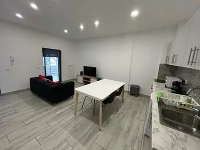 a kitchen with a table and a couch in a room at CASA ANALUCIA in Faro