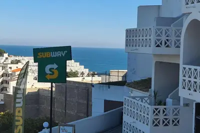 a sign on the side of a building with the ocean at 403 - Oura - 2 bedroom- Sea View in Albufeira