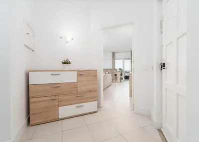 a white kitchen with a wooden dresser and a hallway at 403 - Oura - 2 bedroom- Sea View in Albufeira