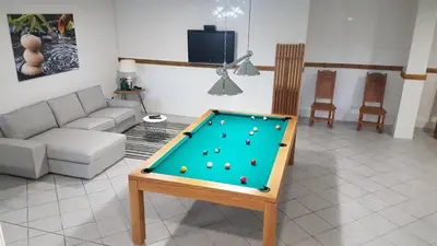 a living room with a pool table in it at Villa Arquete 6 seat Jacuzzi 5 min walk to shops in Guia