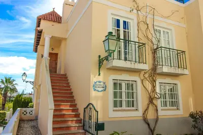 a building with stairs and balconies on it at Two bed Old Village E007 in Vilamoura