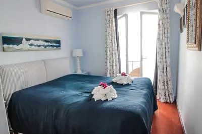 two stuffed animals sitting on top of a bed at Two bed Old Village E007 in Vilamoura