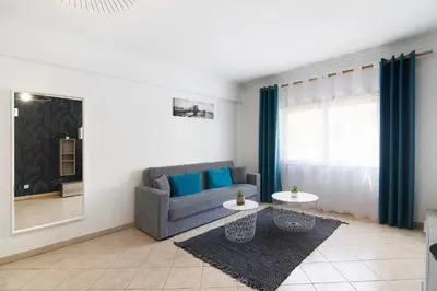 a living room with a couch and a table at Apartamento do Sol in Albufeira