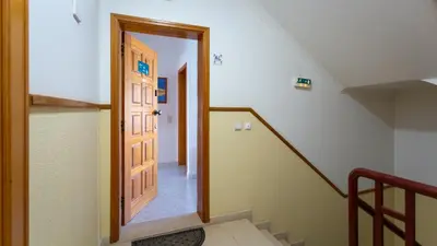 a hallway with a door and stairs in a house at Serene Apartment W/ Balcony and Pool by LovelyStay in Quarteira