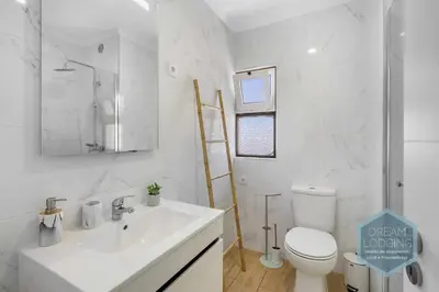 a white bathroom with a sink and a toilet at Vila Magna 109 - Dream Lodging in Albufeira