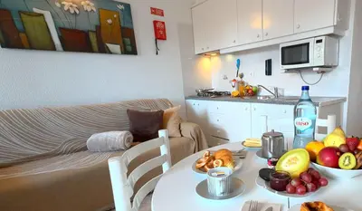 a living room with a table with a bowl of fruit at CH 1 e 2 Two Apartments Up To 10 Guests Casa da Horta, T1 & T2 in Albufeira