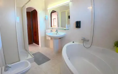 a bathroom with a sink and a tub and a toilet at CH 1 e 2 Two Apartments Up To 10 Guests Casa da Horta, T1 & T2 in Albufeira