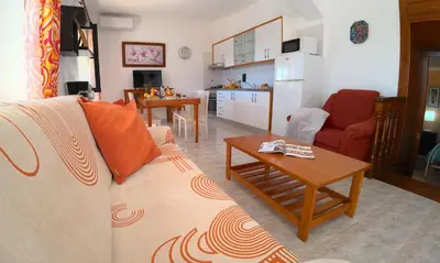a living room with a couch and a table at CH 1 e 2 Two Apartments Up To 10 Guests Casa da Horta, T1 & T2 in Albufeira