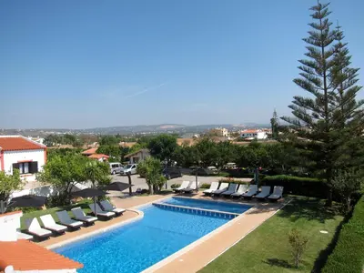 a swimming pool with lounge chairs and a resort at CH 8, 11 e 12 - Casa da Horta 3 x T 1 Apartments Up To 12 Guests in Olhos de Água