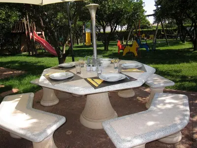 a table and chairs with plates and glasses on it at CH 8, 11 e 12 - Casa da Horta 3 x T 1 Apartments Up To 12 Guests in Olhos de Água