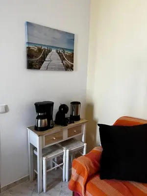 a living room with a table with a coffee maker at CH 8, 11 e 12 - Casa da Horta 3 x T 1 Apartments Up To 12 Guests in Olhos de Água