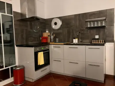 a kitchen with white cabinets and an oven in it at Albufeira studio Bellevista in Albufeira
