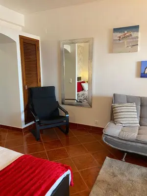 a living room with a couch and a chair at Albufeira studio Bellevista in Albufeira