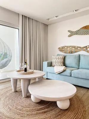 a living room with a couch and a coffee table at Front Sea Apartment Quarteira in Quarteira