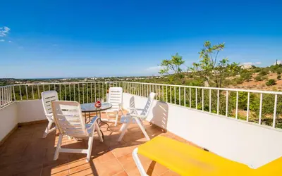 a balcony with chairs and a table on a balcony at Villa Oliandra in Vilamoura