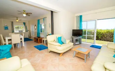a living room with a couch and chairs and a television at Villa Oliandra in Vilamoura