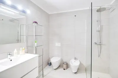 a white bathroom with a sink and a toilet at Modern Oasis 500m Beach with AC WiFi Pool in Albufeira