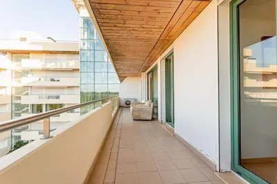 a bedroom with a white bed with pillows and two lamps at Marina Vilamoura - Aquamar 402 By Vilamoura Sun in Quarteira
