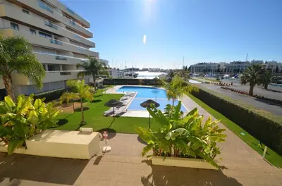 a balcony with a table and chairs and a view of a street at Marina Vilamoura - Aquamar 402 By Vilamoura Sun in Quarteira