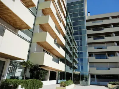 a green yard next to a building at Marina Vilamoura - Aquamar 402 By Vilamoura Sun in Quarteira