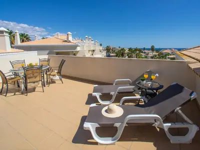 a patio with tables and chairs on a roof at Apartment Penthouse Milea by Interhome in Patroves