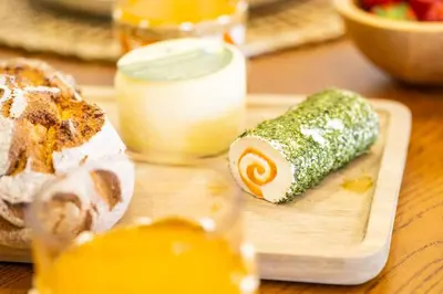 a wooden cutting board with a piece of sushi and bread at Apartment Riu - Close to bars shops and restaurants in Albufeira