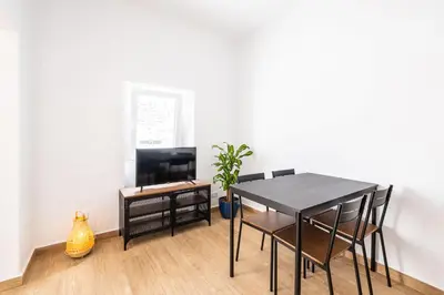 a dining room with a black table and chairs at Apartment Santana - In the heart of Albufeira in Albufeira
