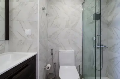 a bathroom with a shower and a toilet and a sink at Marina Vision Vilamoura in Vilamoura