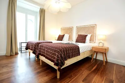 a bedroom with a large bed and a window at Green Algarve Gem Spacious 2 BDR By Misha's Place in Faro