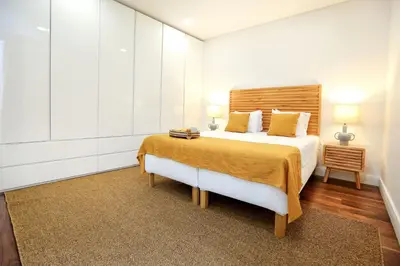 a bedroom with a large bed and two lamps at Green Algarve Gem Spacious 2 BDR By Misha's Place in Faro